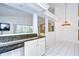 Open-concept kitchen and dining area with granite countertops and bright white walls at 18828 Rue Loire, Lutz, FL 33558