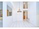 Open-concept dining room with tile floors and stylish chandelier at 18828 Rue Loire, Lutz, FL 33558