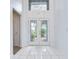 Bright entryway featuring tile flooring, high ceilings, and a decorative front door at 18828 Rue Loire, Lutz, FL 33558