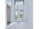 Bright entryway featuring tile flooring, high ceilings, and a decorative front door at 18828 Rue Loire, Lutz, FL 33558