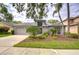 Charming single-story home with manicured landscaping and a two-car garage on a sunny day at 18828 Rue Loire, Lutz, FL 33558