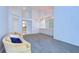 Open-concept space with carpet flooring, a chandelier, and neutral wall colors at 18828 Rue Loire, Lutz, FL 33558
