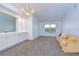 Bright living room with carpet floors, neutral walls, and a built-in cabinet with mirror at 18828 Rue Loire, Lutz, FL 33558