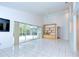Bright living room features tiled floors, high ceilings with a ceiling fan, and sliding glass doors to the patio at 18828 Rue Loire, Lutz, FL 33558