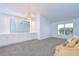 Bright living room with carpet floors, neutral walls, and a built-in cabinet with mirror at 18828 Rue Loire, Lutz, FL 33558