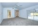 Bright main bedroom features carpeted floors, high ceilings with a ceiling fan, and views to the main bathroom at 18828 Rue Loire, Lutz, FL 33558