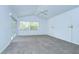 Bright main bedroom features carpeted floors, high ceilings with a ceiling fan, and a large window at 18828 Rue Loire, Lutz, FL 33558
