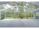 Large screened patio offering ample space for outdoor seating with view of backyard at 18828 Rue Loire, Lutz, FL 33558