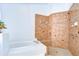 A walk-in shower with tiled walls and a bathtub sitting next to each other at 18828 Rue Loire, Lutz, FL 33558