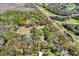 Aerial shot of land outlined in red with house, pool and golf course nearby at 2690 E Lake Trl, Tarpon Springs, FL 34688