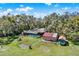 Aerial view of home with screened-in pool and detached building at 2690 E Lake Trl, Tarpon Springs, FL 34688