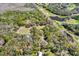 A large lot with a pool and plenty of trees surrounded by a golf course and ponds at 2690 E Lake Trl, Tarpon Springs, FL 34688