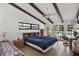 Bedroom featuring exposed beam ceilings, neutral walls, tile floors, and french doors to the outdoors at 2690 E Lake Trl, Tarpon Springs, FL 34688