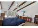 Bedroom featuring exposed beam ceilings, neutral walls, tile floors, and french doors to the outdoors at 2690 E Lake Trl, Tarpon Springs, FL 34688