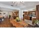 Cozy dining area with wood floors, open to the kitchen and other living spaces, perfect for Gathering meals at 2690 E Lake Trl, Tarpon Springs, FL 34688