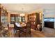 Elegant dining room featuring a vintage chandelier, hardwood floors, and large windows offering scenic views at 2690 E Lake Trl, Tarpon Springs, FL 34688