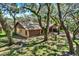 Exterior of a home with mature trees, surrounded by lush greenery, enhancing its curb appeal at 2690 E Lake Trl, Tarpon Springs, FL 34688