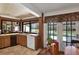 Bright kitchen with a pool view window, light wooden cabinets, and easy access to the outdoor area at 2690 E Lake Trl, Tarpon Springs, FL 34688