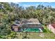 Aerial shot of the home's backyard pool and screened enclosure at 2690 E Lake Trl, Tarpon Springs, FL 34688