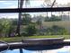 Pool overlooks manicured lawn and tropical landscaping at 28 Sportsman Pl, Rotonda West, FL 33947