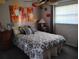 Cozy bedroom with colorful artwork, a ceiling fan, and a comfortable bed with decorative pillows at 28 Sportsman Pl, Rotonda West, FL 33947