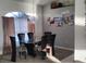 Bright dining room with a glass table, chandelier, and art on the wall at 28 Sportsman Pl, Rotonda West, FL 33947