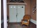 Charming front porch with double doors and comfortable wicker rocking chair at 28 Sportsman Pl, Rotonda West, FL 33947