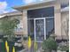 Inviting screened entrance with decorative front door and lush landscaping at 28 Sportsman Pl, Rotonda West, FL 33947