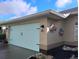 Spacious two-car garage with a light blue door and colorful wall art at 28 Sportsman Pl, Rotonda West, FL 33947
