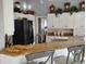 Kitchen bar area features granite counters, white cabinets, and barstool seating at 28 Sportsman Pl, Rotonda West, FL 33947