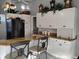 Kitchen with white cabinetry, granite counters, and a view of barstool seating at 28 Sportsman Pl, Rotonda West, FL 33947