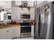 Bright kitchen with stainless steel appliances and white cabinetry at 28 Sportsman Pl, Rotonda West, FL 33947