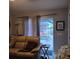 Relaxing living room with comfortable seating and sliding glass doors leading to a private pool area at 28 Sportsman Pl, Rotonda West, FL 33947