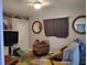 Comfortable living room with a floral rug, wall mirrors, a TV, and natural light from a window at 28 Sportsman Pl, Rotonda West, FL 33947