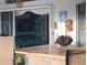 Outdoor patio featuring a bar with granite countertop with a view to an outdoor living area with TV at 28 Sportsman Pl, Rotonda West, FL 33947