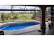 A beautiful in-ground swimming pool and hot tub overlook a professionally landscaped yard at 28 Sportsman Pl, Rotonda West, FL 33947
