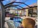 Sparkling pool and hot tub are enclosed with a screened lanai and comfortable seating at 28 Sportsman Pl, Rotonda West, FL 33947