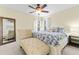 Bright main bedroom with neutral colors, a ceiling fan, and a chaise lounge at 2886 Armadillo Dr, Palm Harbor, FL 34683