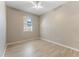 Bright bedroom features light, neutral walls, light wood floors, and a ceiling fan at 3031 Downan Point Dr, Land O Lakes, FL 34638