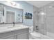 Well-lit bathroom with grey vanity, modern fixtures, and walk-in shower with a glass door at 3111 Pass A Grille Way # 213, St Pete Beach, FL 33706