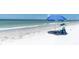 Sunny beach view with a beach umbrella and blue sky at 3111 Pass A Grille Way # 213, St Pete Beach, FL 33706