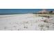 Expansive beach view with soft white sand and a luxury hotel in the distance at 3111 Pass A Grille Way # 213, St Pete Beach, FL 33706
