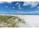 Beach view with sea oats, featuring a sunny day with clear blue skies at 3111 Pass A Grille Way # 213, St Pete Beach, FL 33706