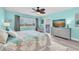 Comfortable bedroom featuring cool toned walls, a floral patterned bedspread, and a large window at 3111 Pass A Grille Way # 213, St Pete Beach, FL 33706