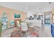 A charming dining area features a round table with seating for four, bright natural light, and modern decor at 3111 Pass A Grille Way # 213, St Pete Beach, FL 33706