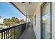 Exterior hallway with view of palm trees and hotel at 3111 Pass A Grille Way # 213, St Pete Beach, FL 33706