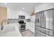 Well-equipped kitchen showcasing stainless steel appliances, quartz countertops, and ample cabinet space at 3111 Pass A Grille Way # 213, St Pete Beach, FL 33706