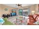 Inviting living room with a balcony access, a large TV, and a comfortable seating area at 3111 Pass A Grille Way # 213, St Pete Beach, FL 33706