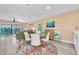 Comfortable living room with coastal decor, balcony access, and a dining area perfect for relaxing and entertaining at 3111 Pass A Grille Way # 213, St Pete Beach, FL 33706