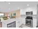 Bright living space with an open layout showing the kitchen, dining, and living room areas at 3111 Pass A Grille Way # 213, St Pete Beach, FL 33706